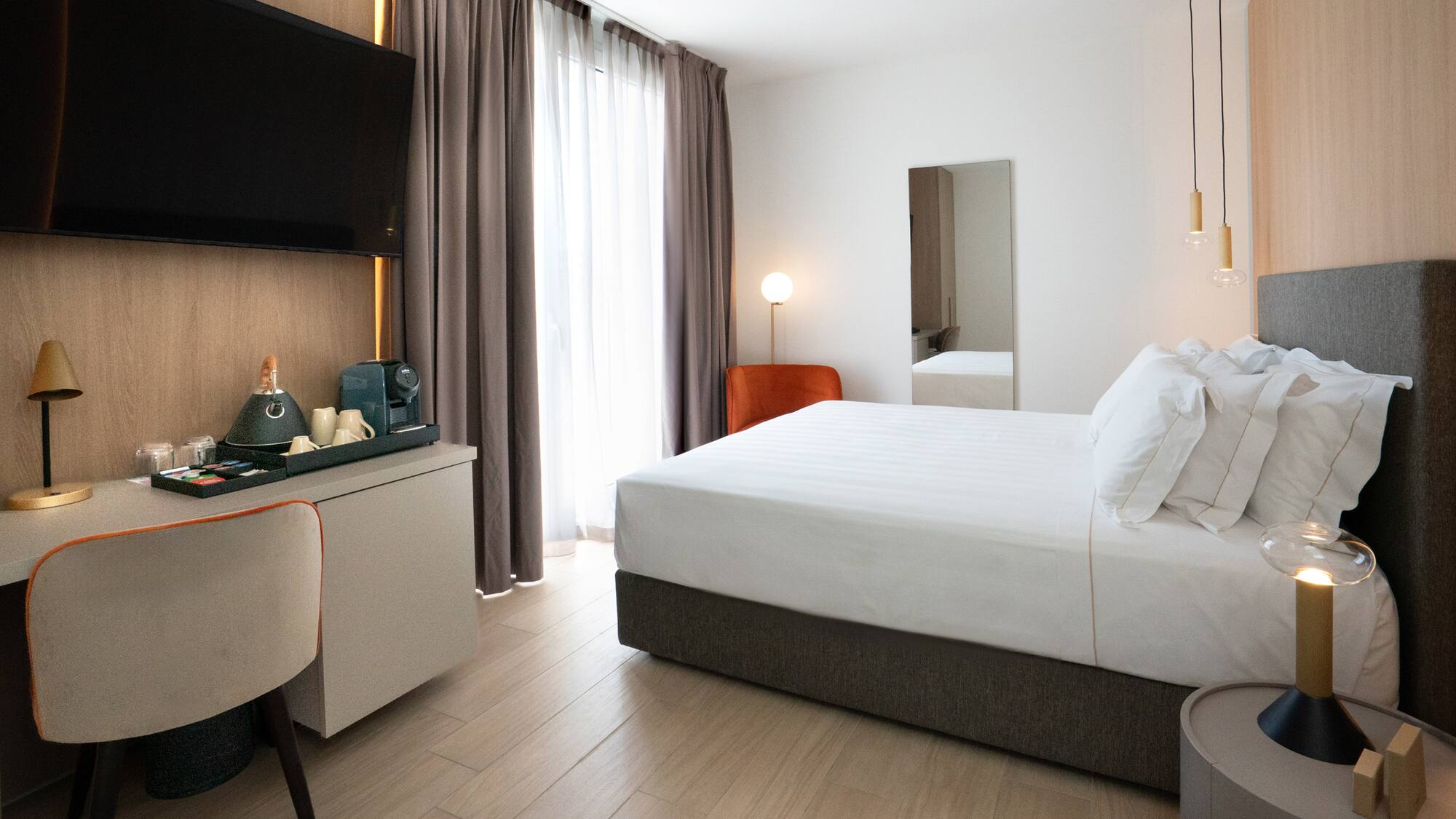 a room with a bed and a mirror