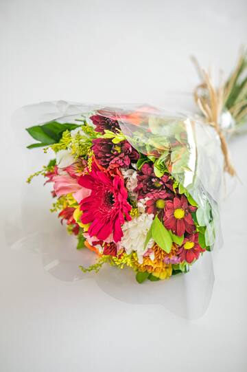 a bouquet of flowers wrapped in plastic
