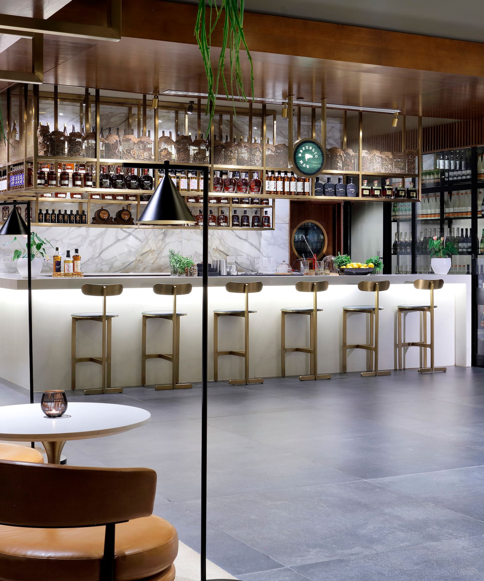 a room with a bar and chairs