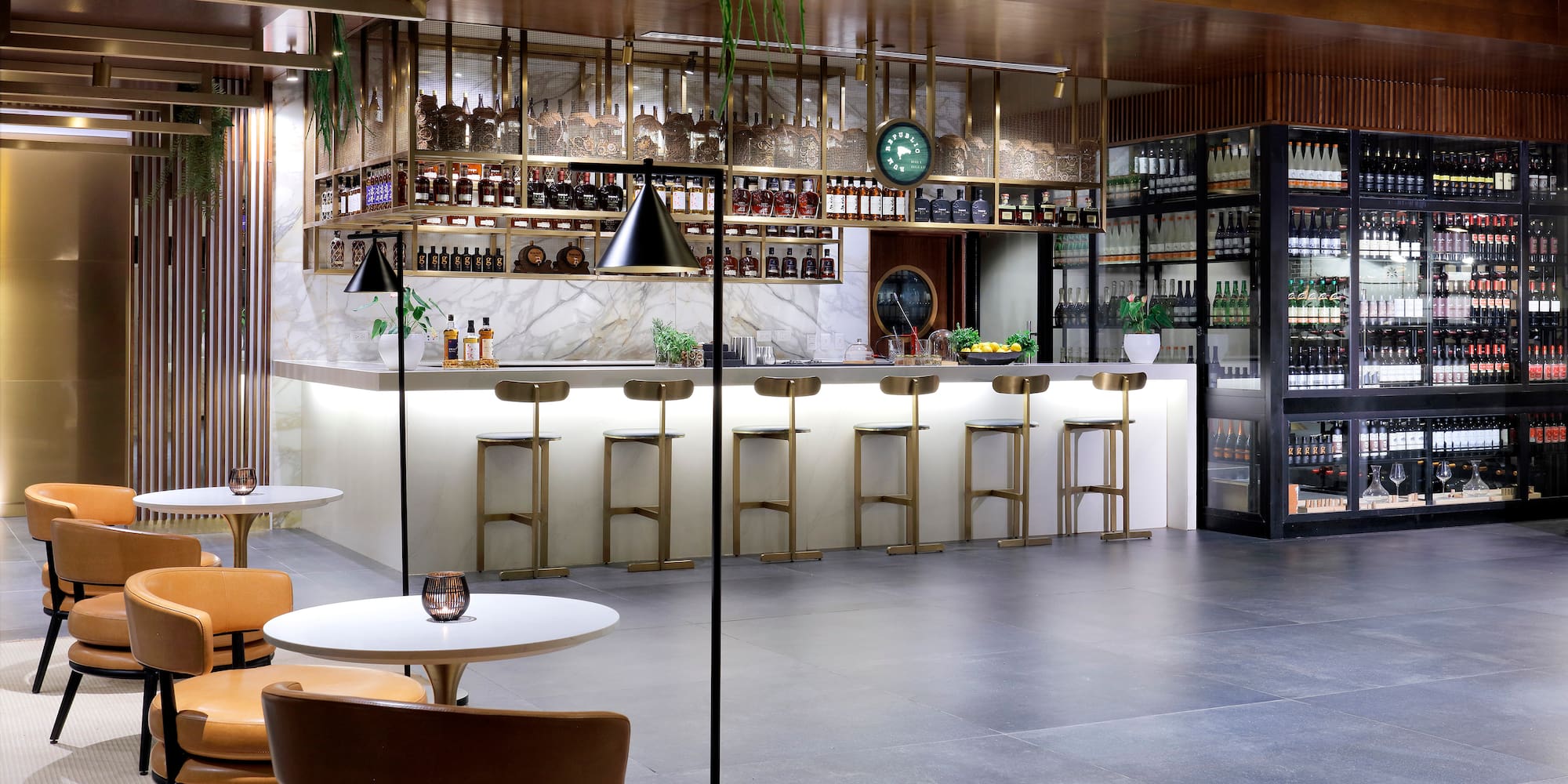 a room with a bar and chairs