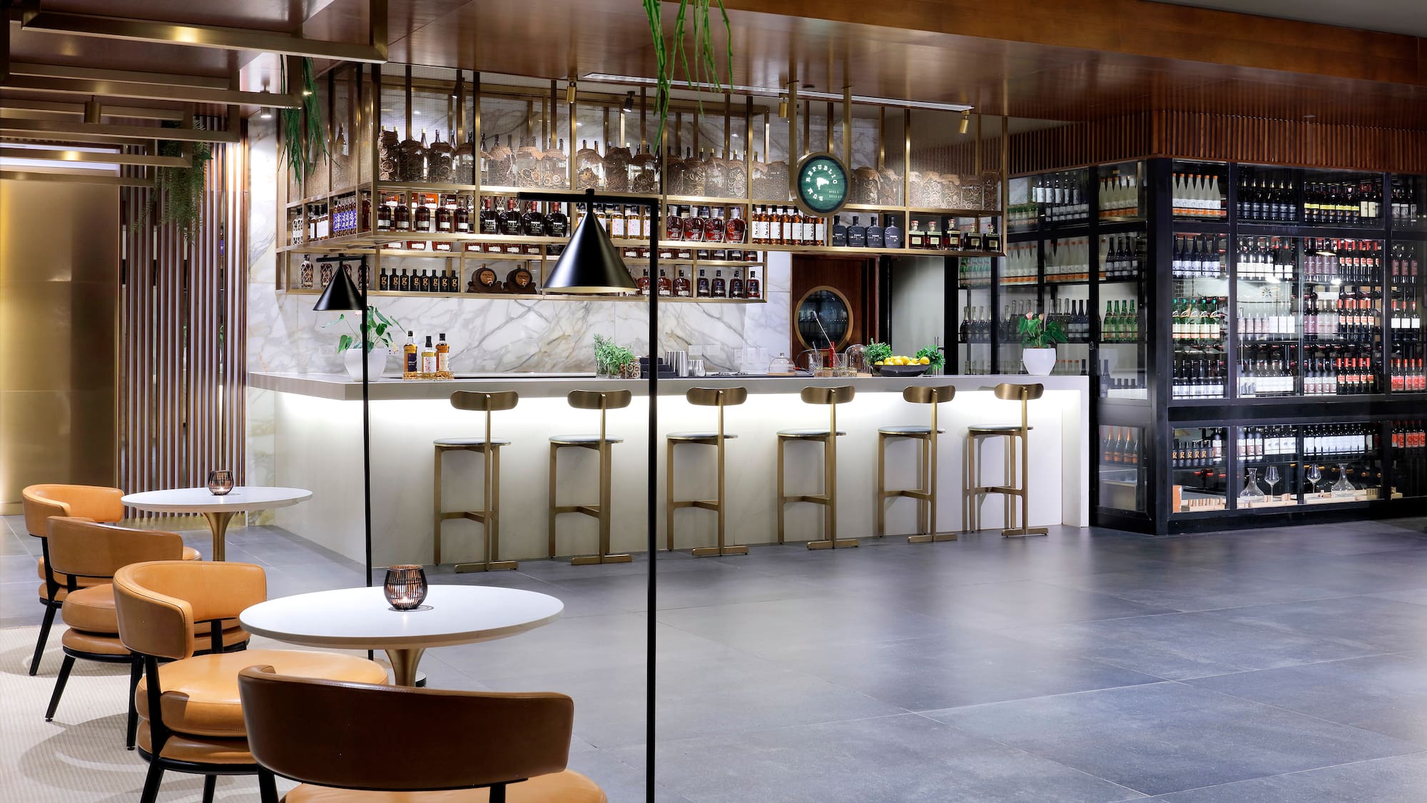 a room with a bar and chairs