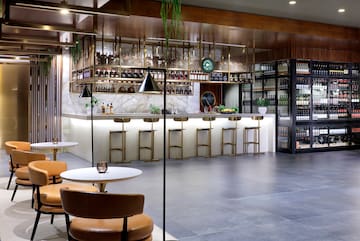 a room with a bar and chairs