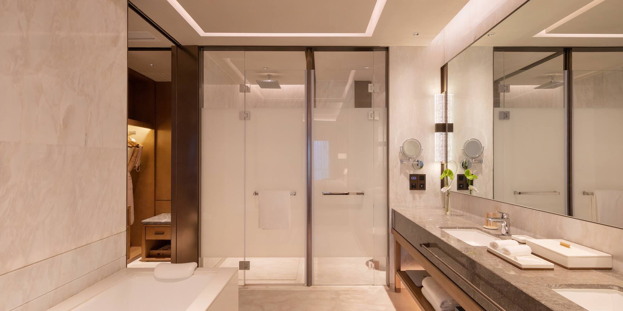 a bathroom with a glass shower and a bathtub