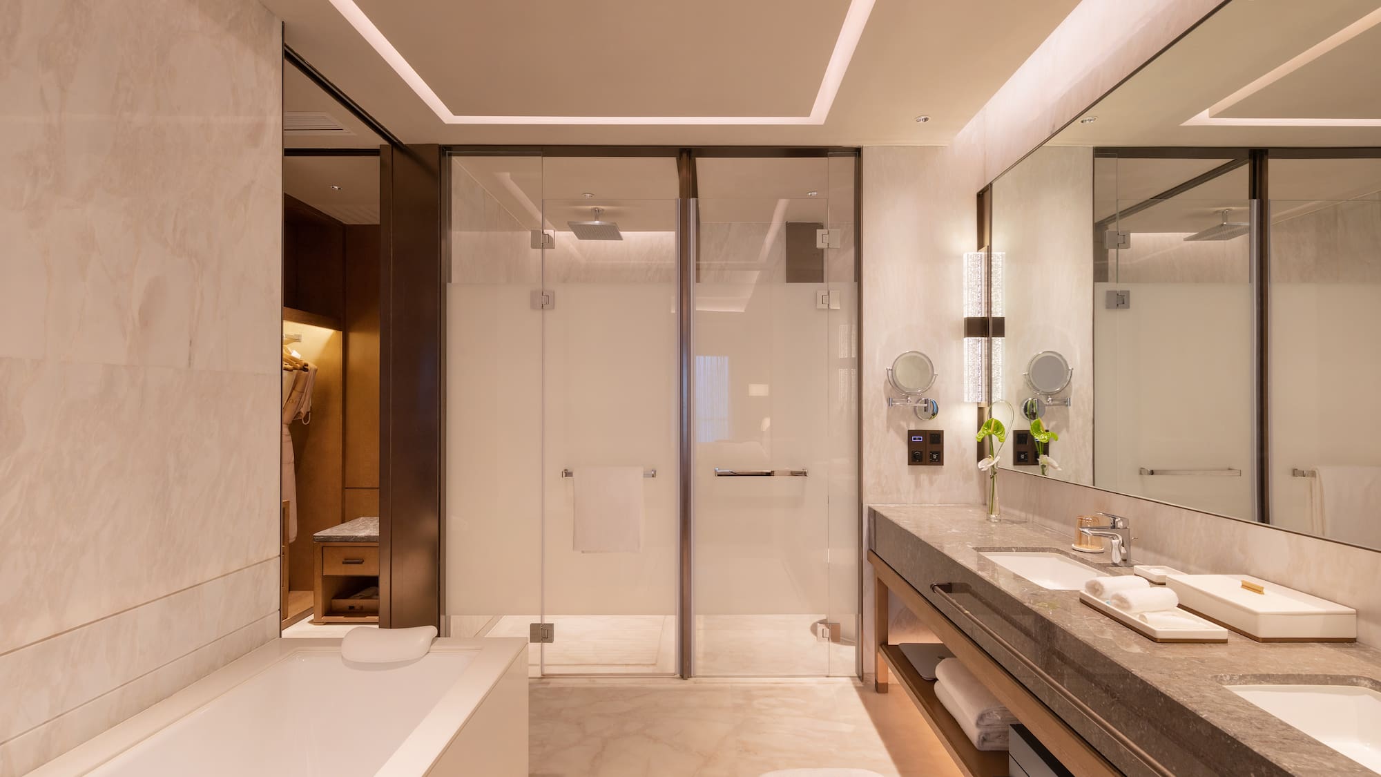 a bathroom with a glass shower and a bathtub
