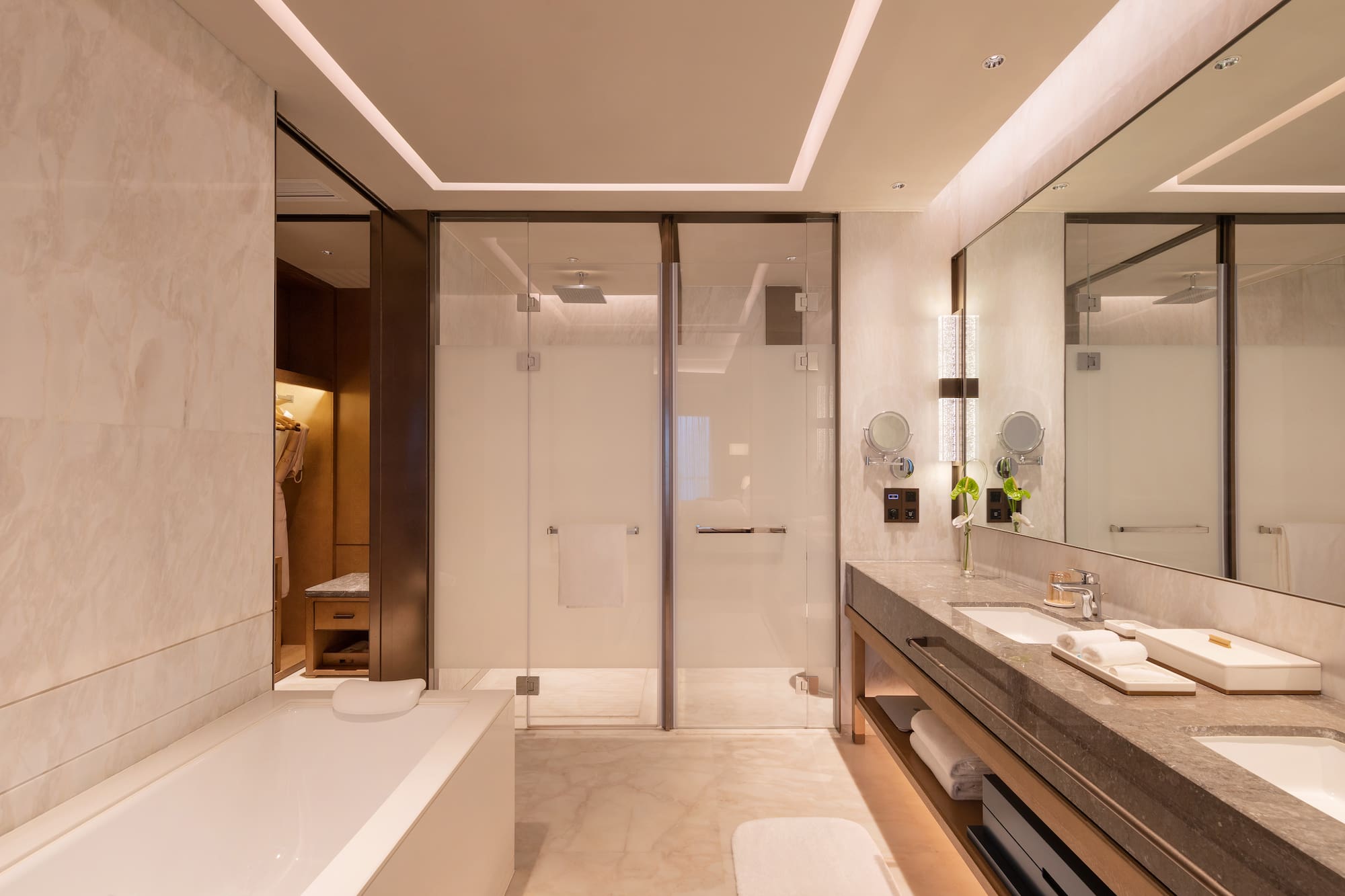 a bathroom with a glass shower and a bathtub