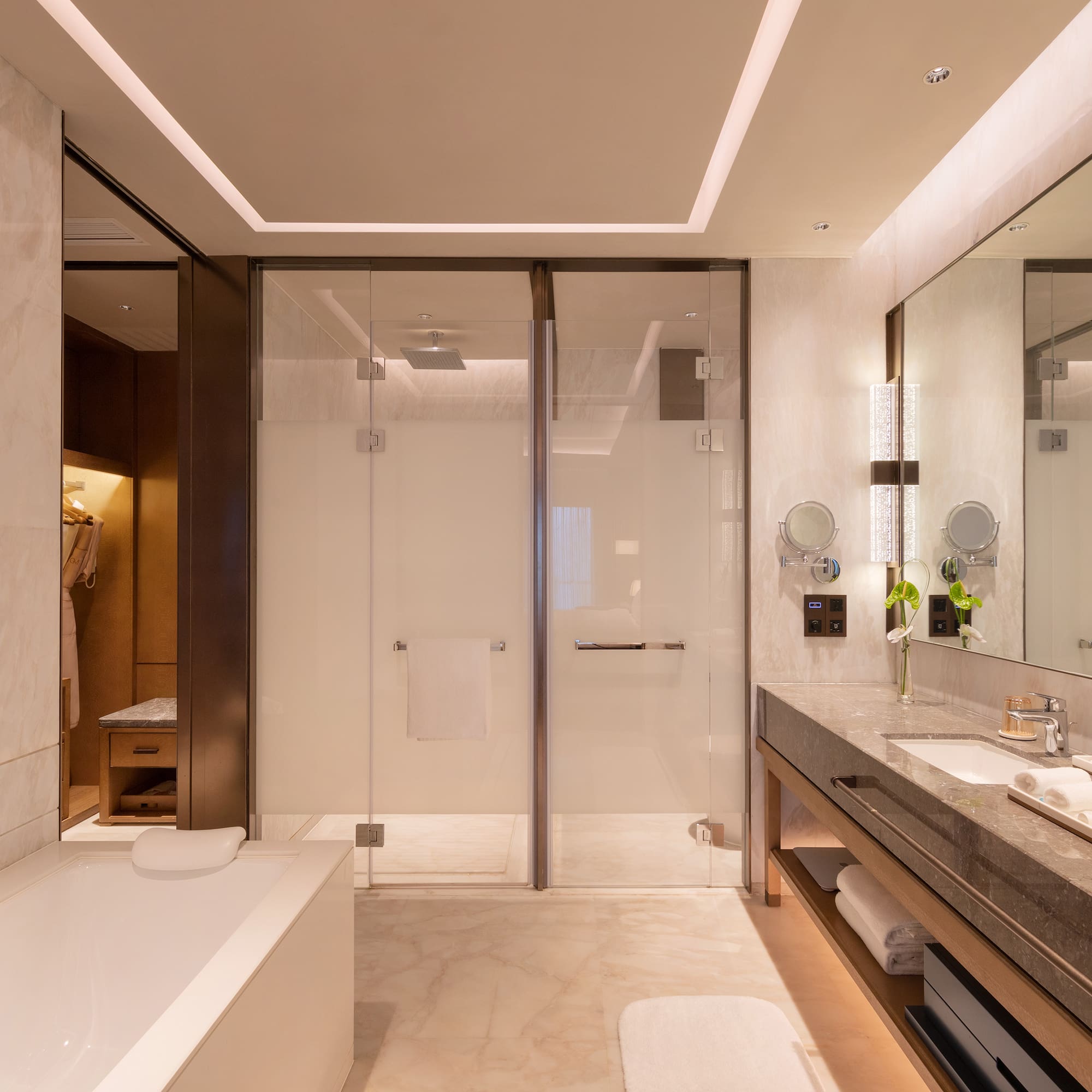 a bathroom with a glass shower and a bathtub