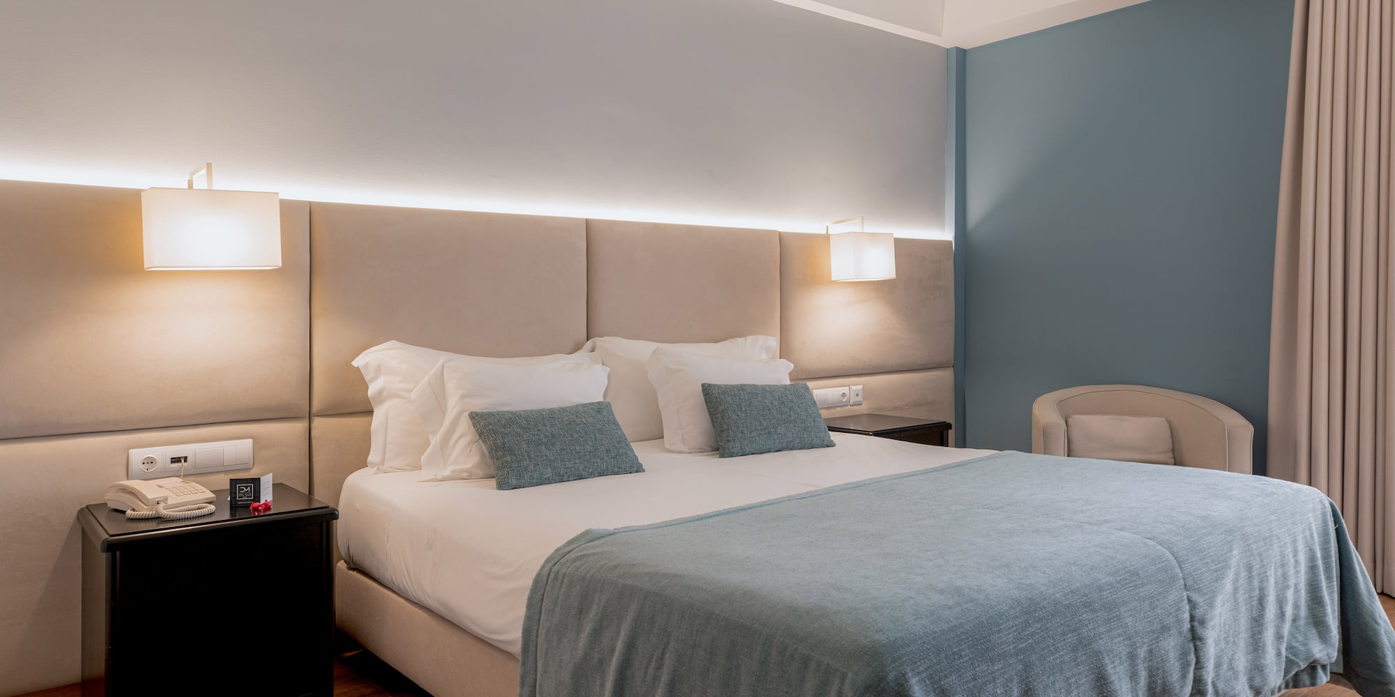 a bed with a headboard and a chair