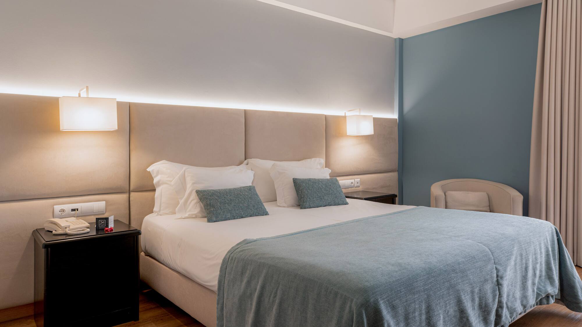 a bed with a headboard and a chair