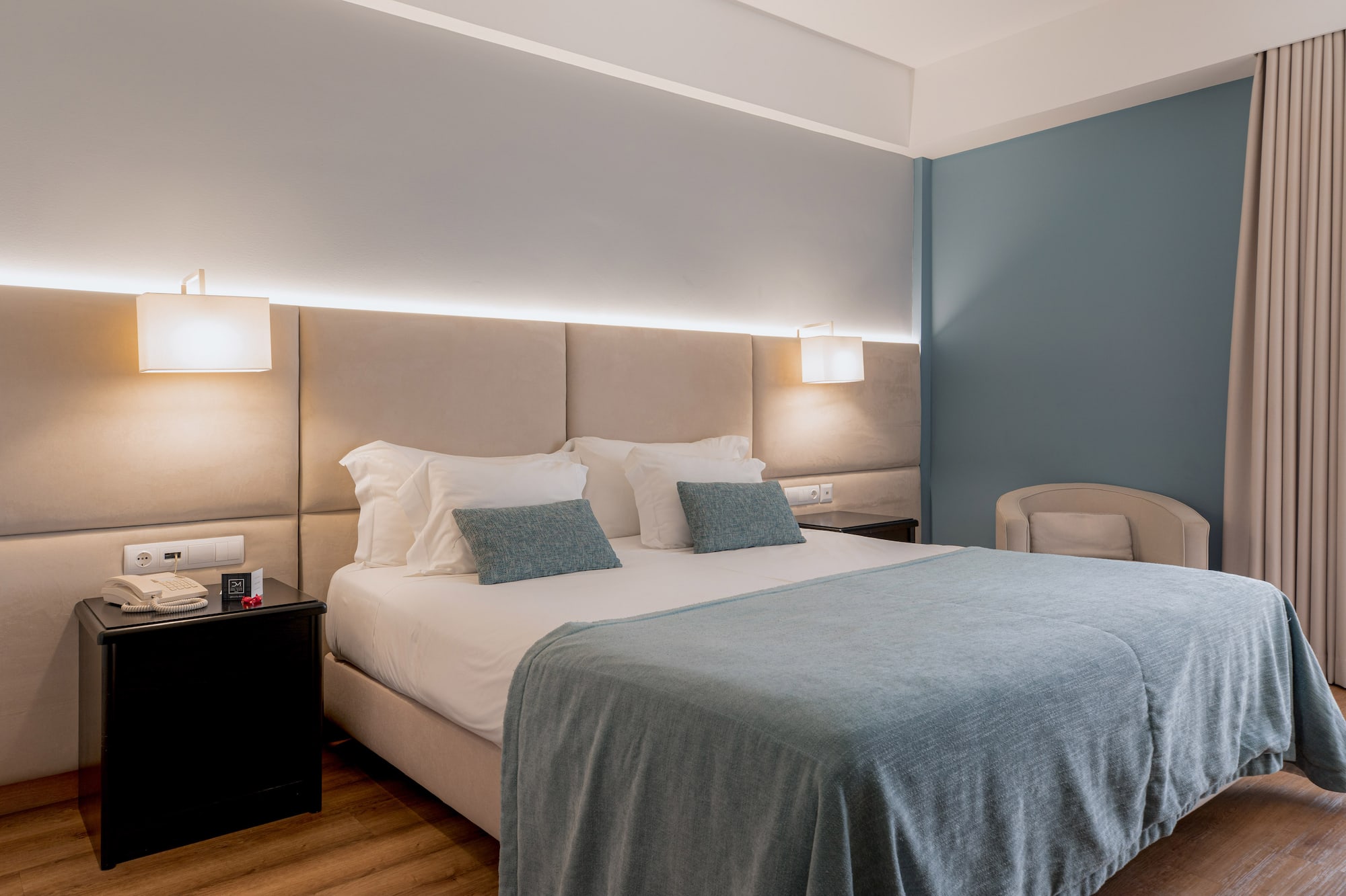 a bed with a headboard and a chair