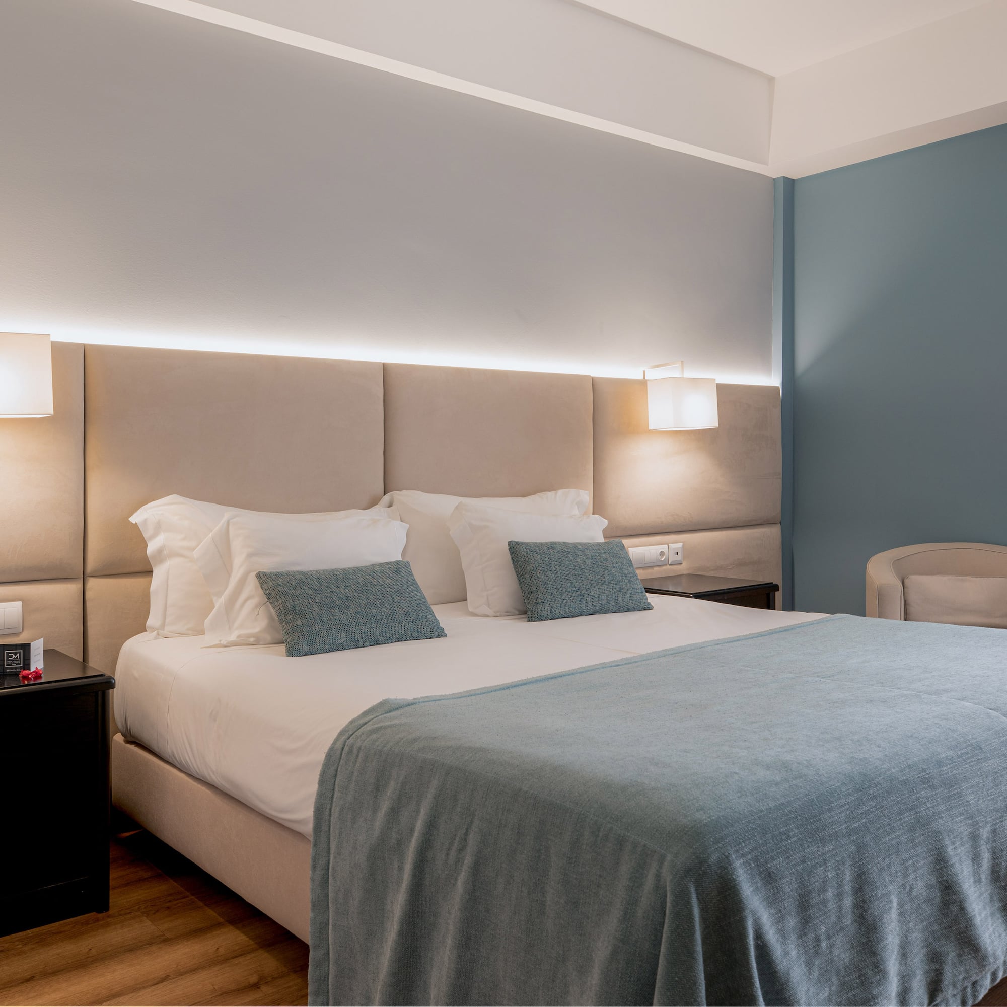 a bed with a headboard and a chair