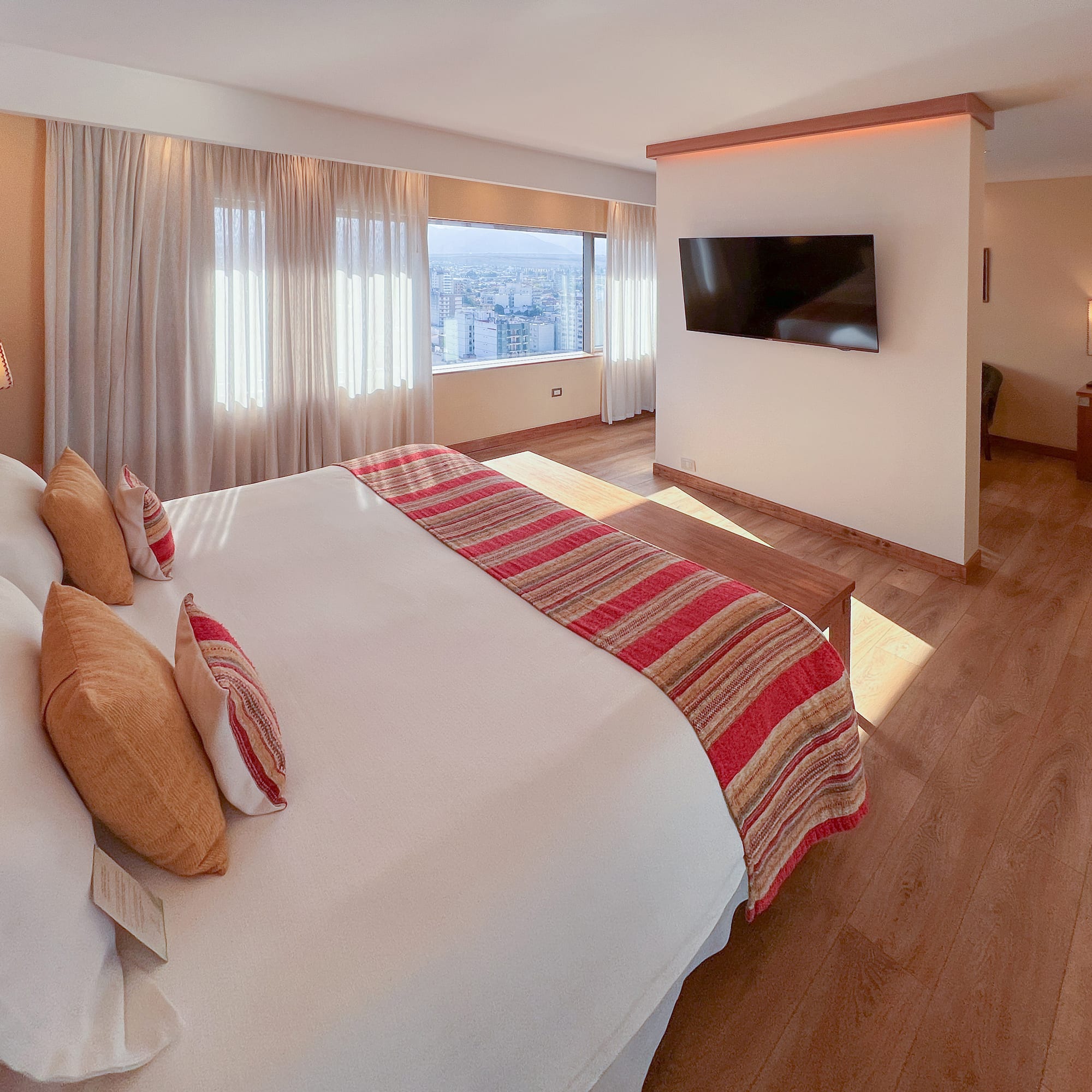 a room with a bed and a television