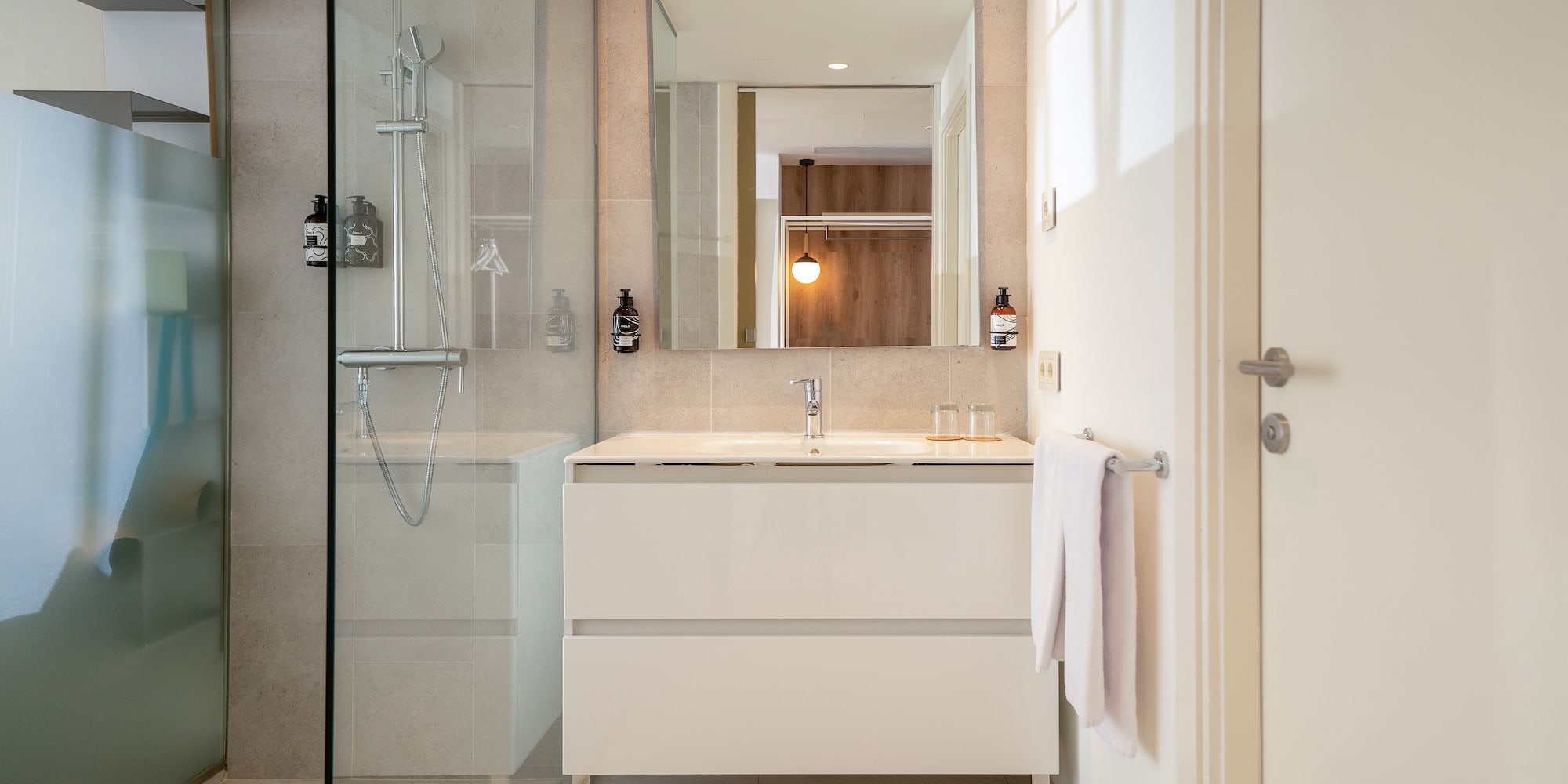 a bathroom with a mirror and a shower