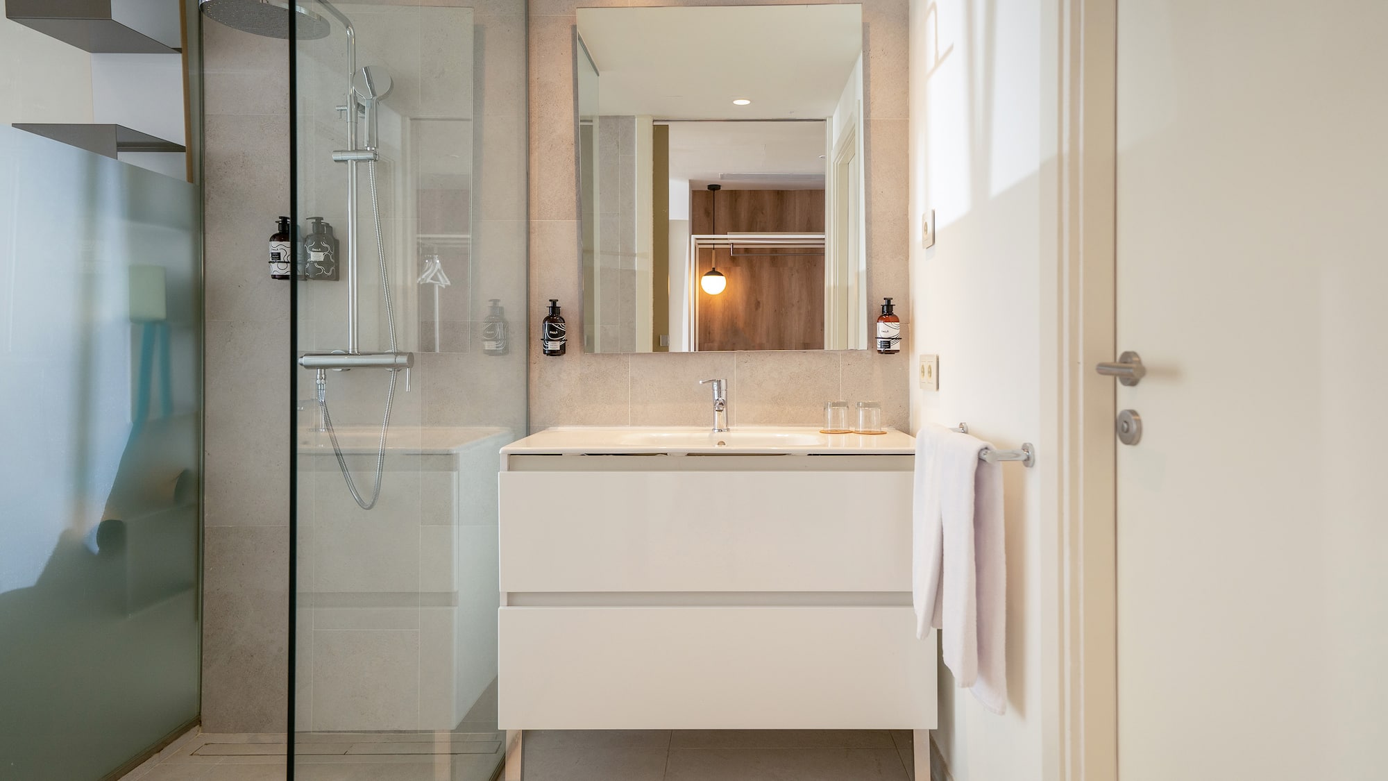 a bathroom with a mirror and a shower