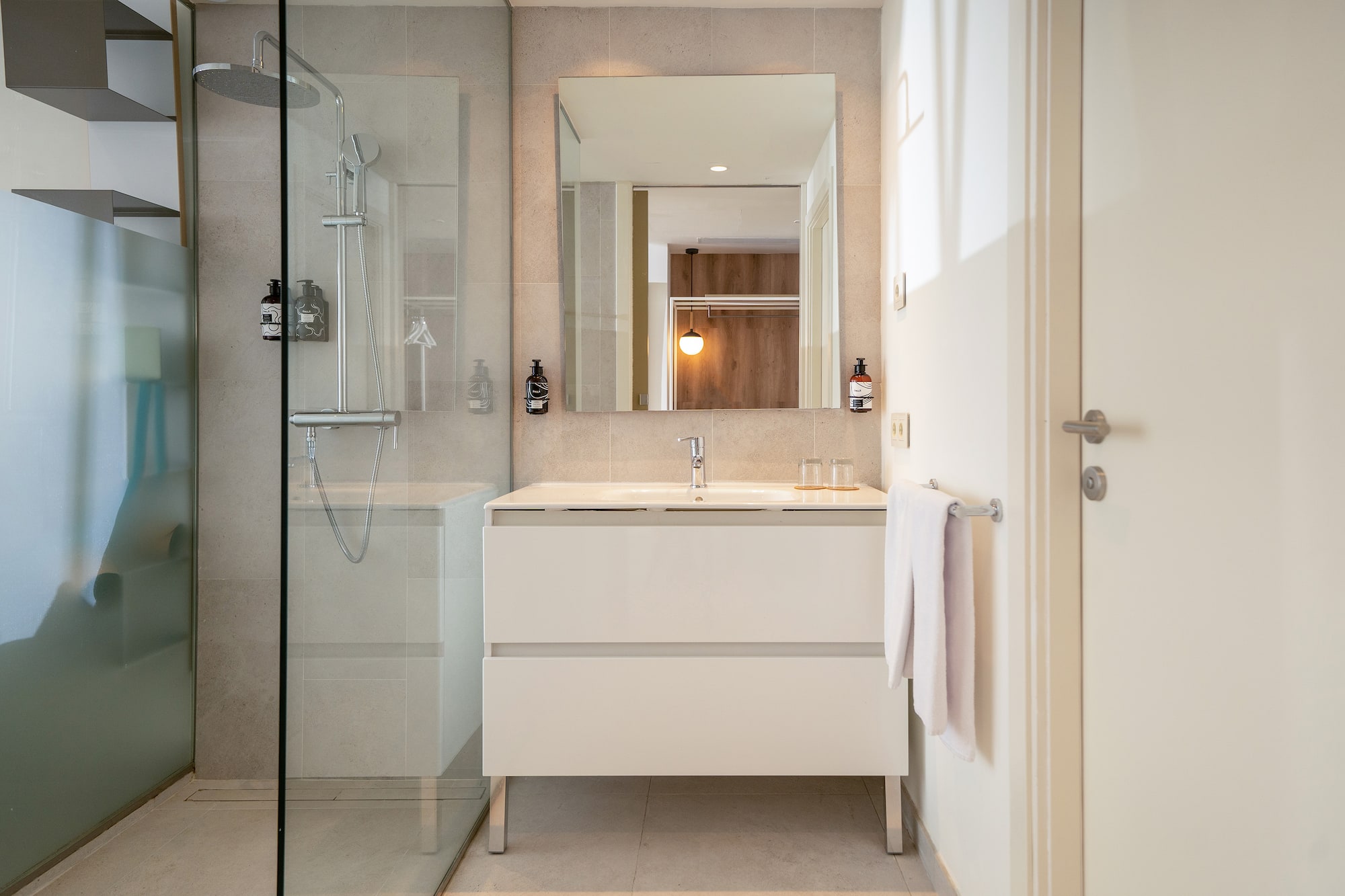 a bathroom with a mirror and a shower