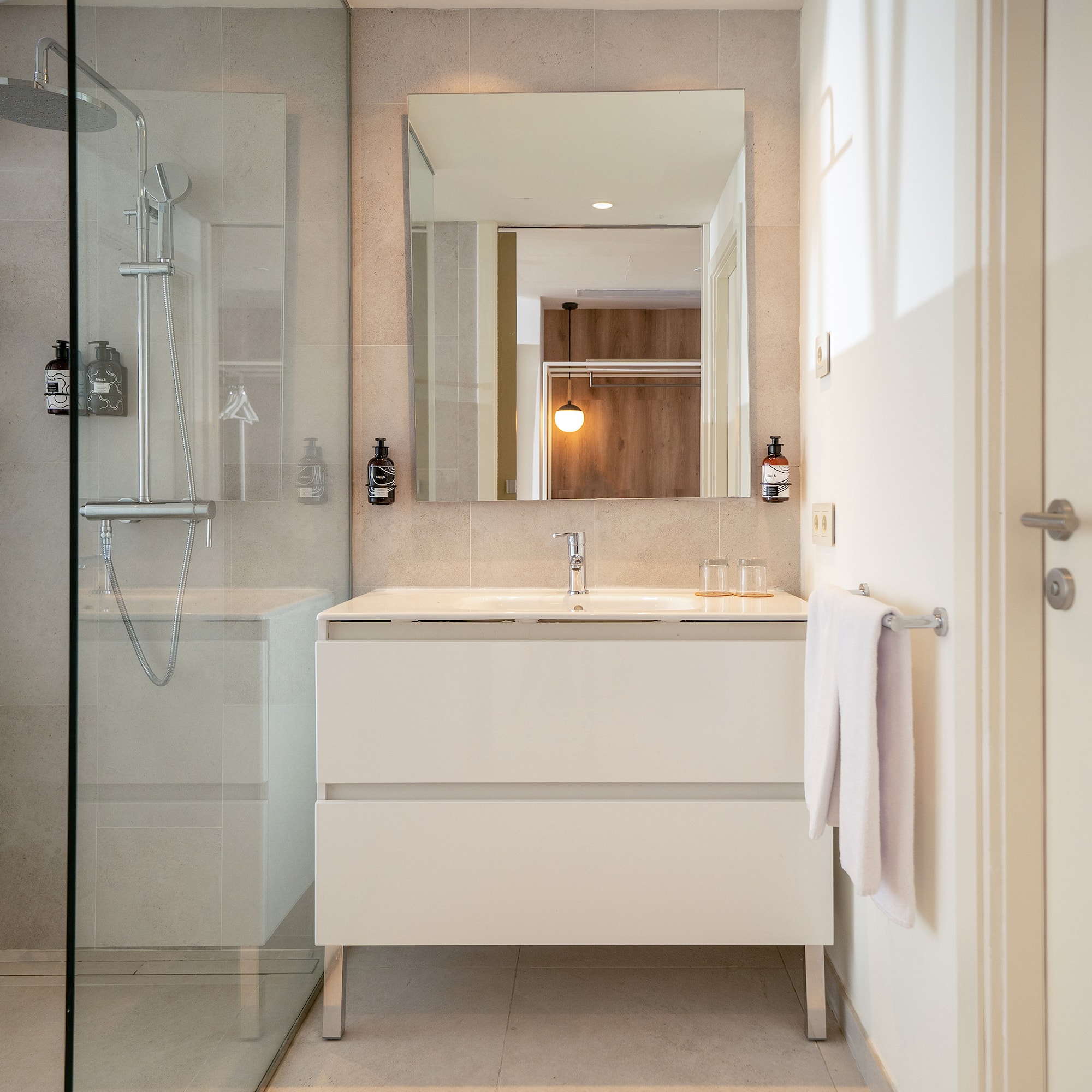 a bathroom with a mirror and a shower