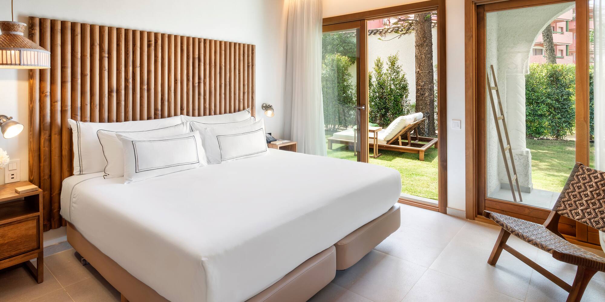 a bed in a room with a glass door