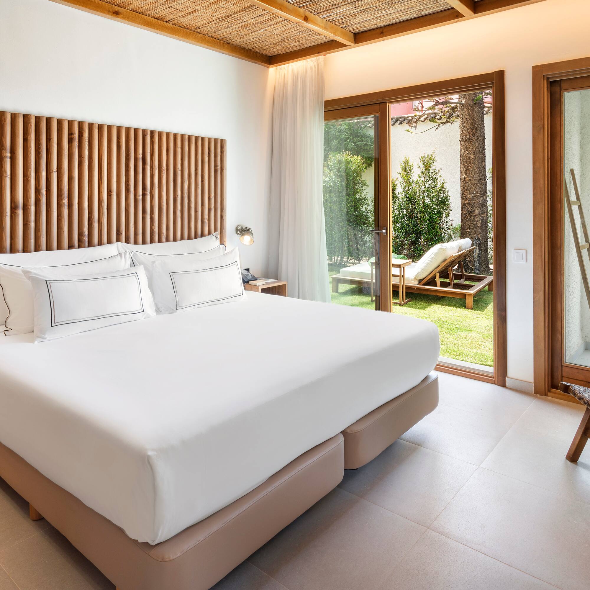 a bed in a room with a glass door