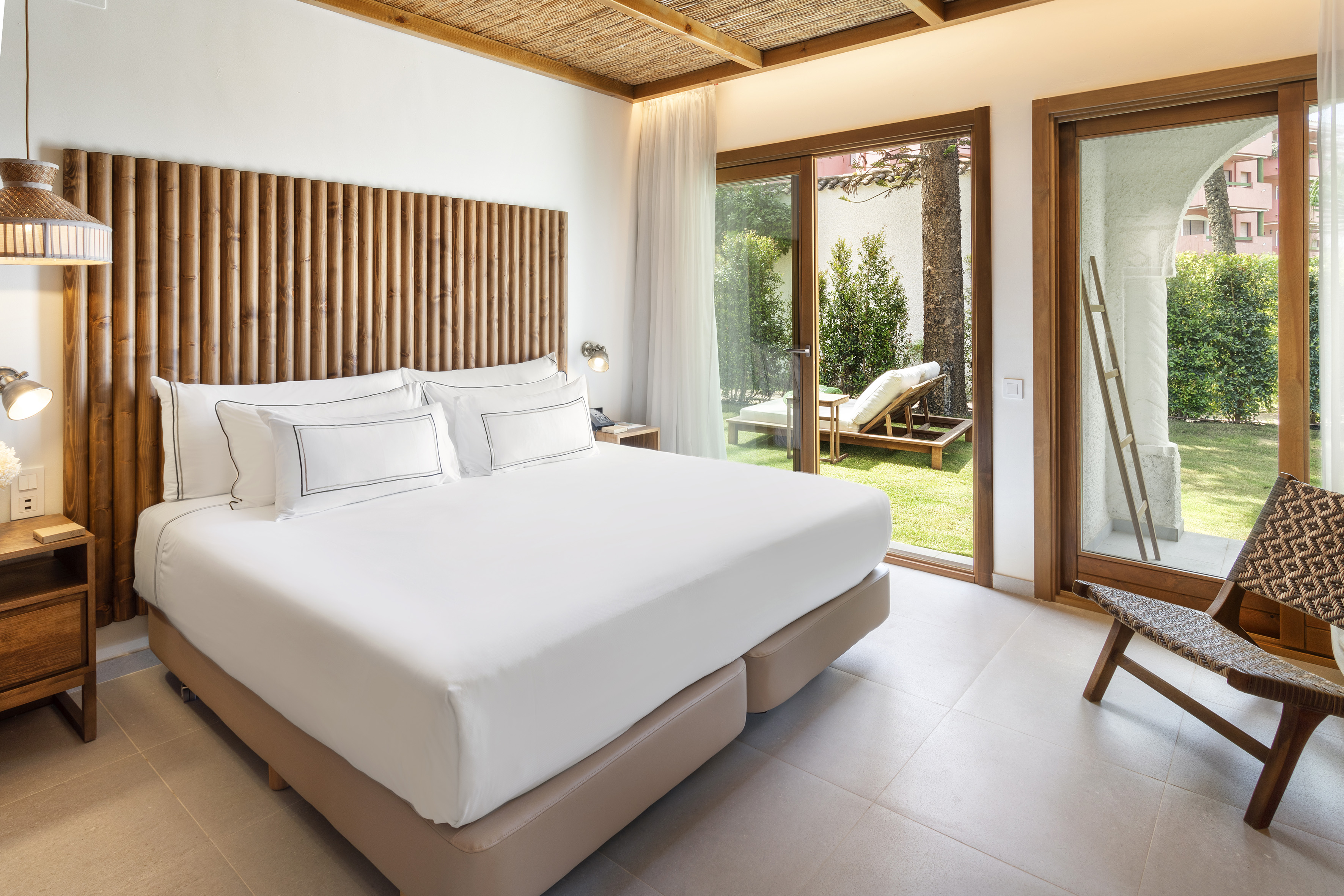 a bed in a room with a glass door