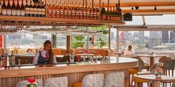 a bar with a counter and chairs