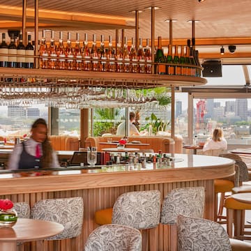 a bar with a counter and chairs