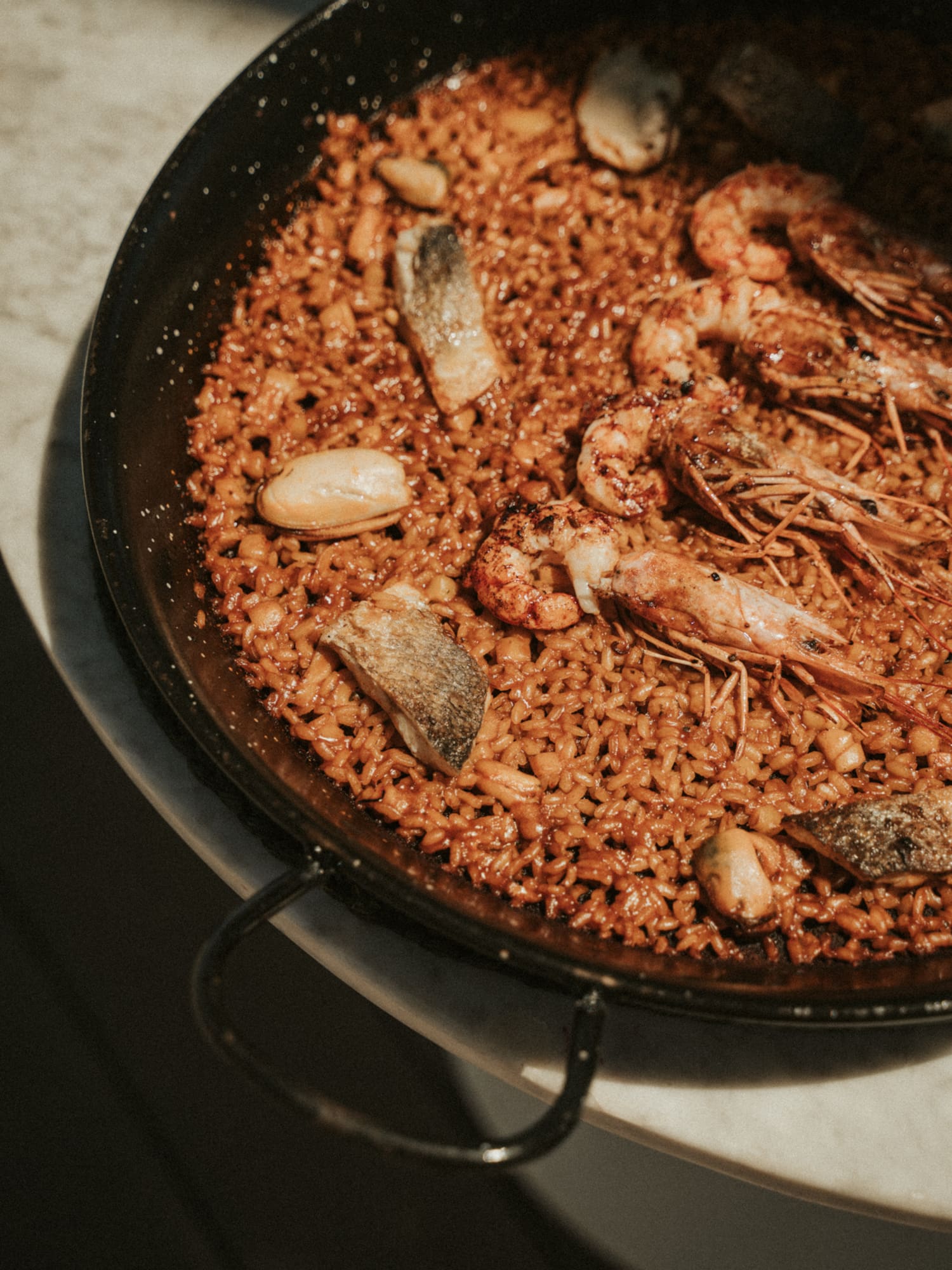 a pan of rice with shrimp and fish