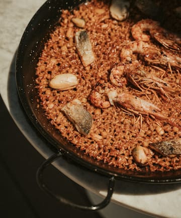 a pan of rice with shrimp and fish