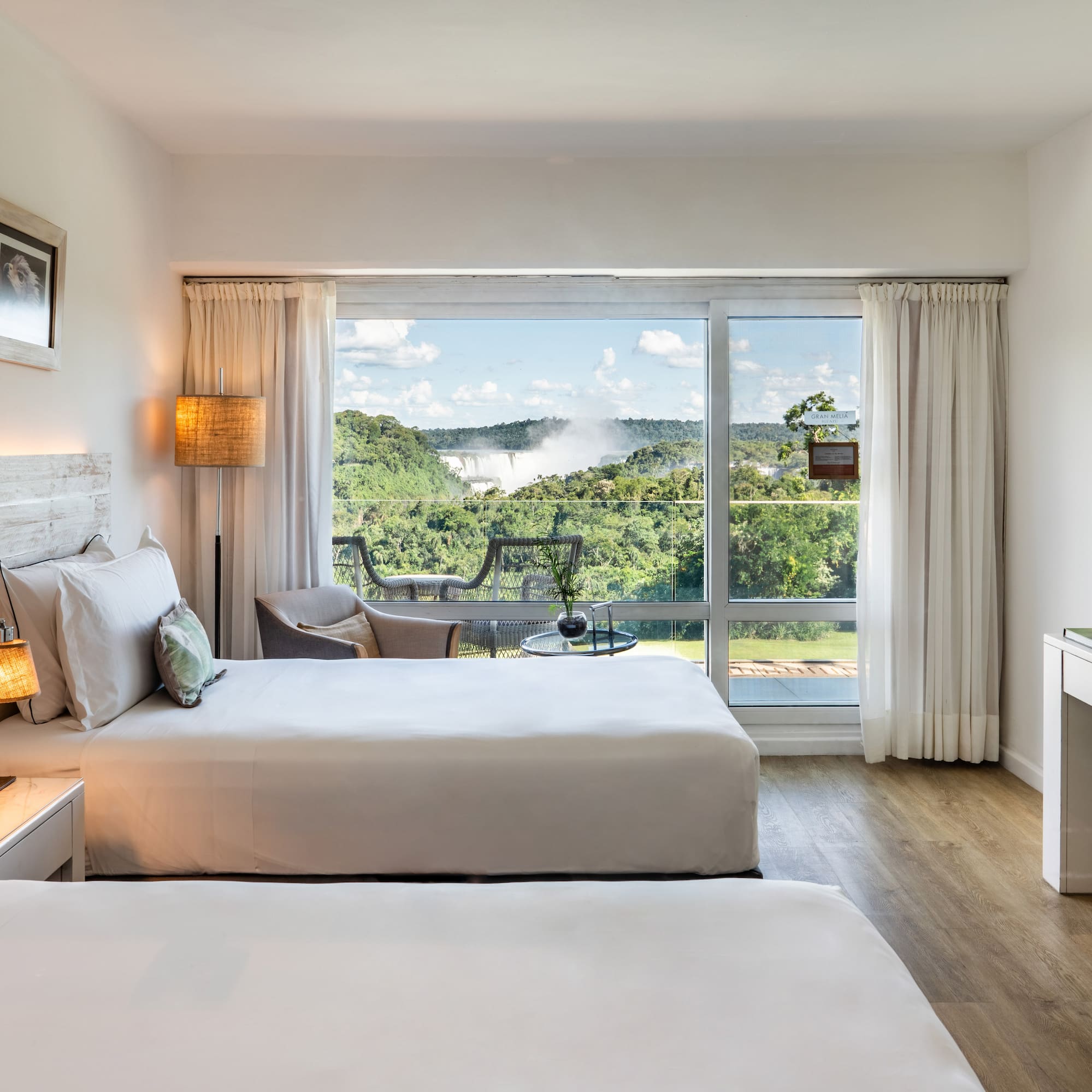 a room with two beds and a large window