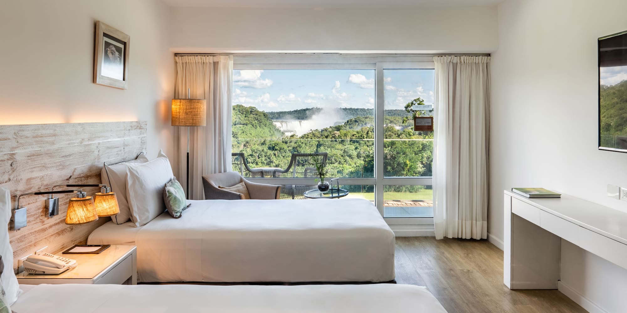 a room with two beds and a large window