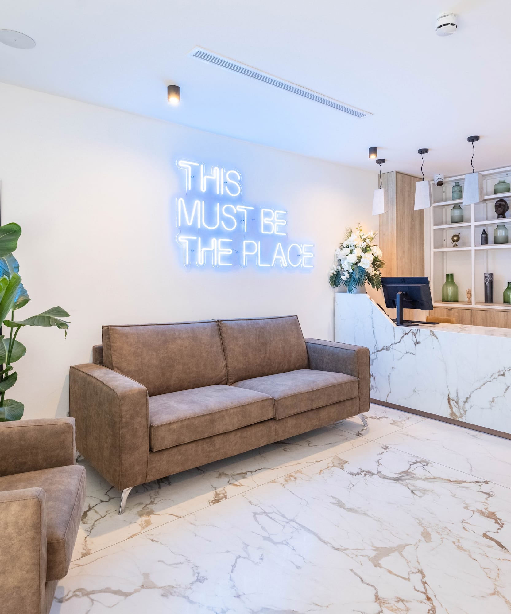 a room with a reception desk and a couch