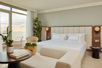 a bedroom with a large bed and a table