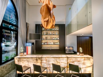 a bar with a counter and a bar with a bar and a shelf with bottles