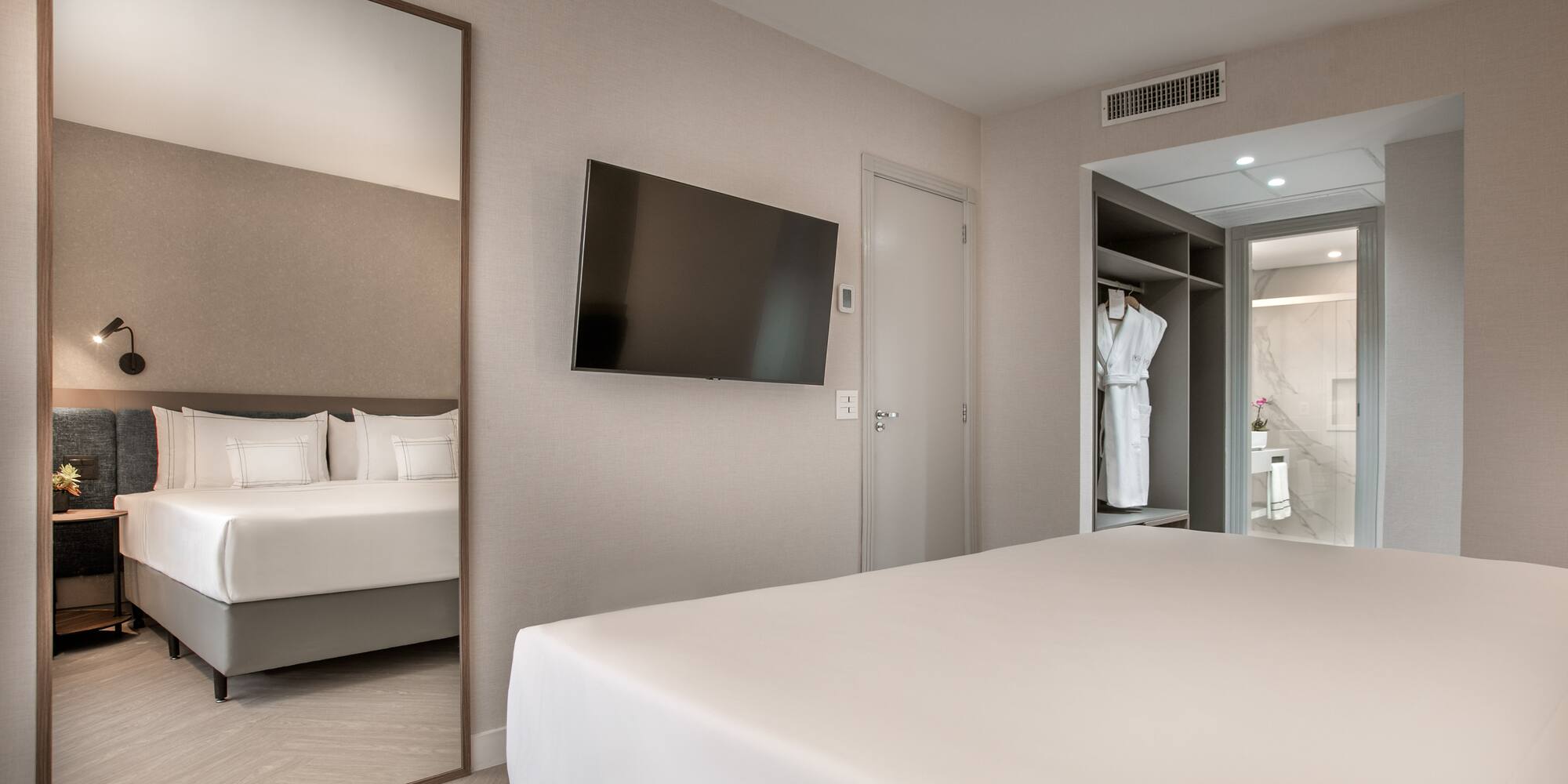 a room with a bed and a mirror