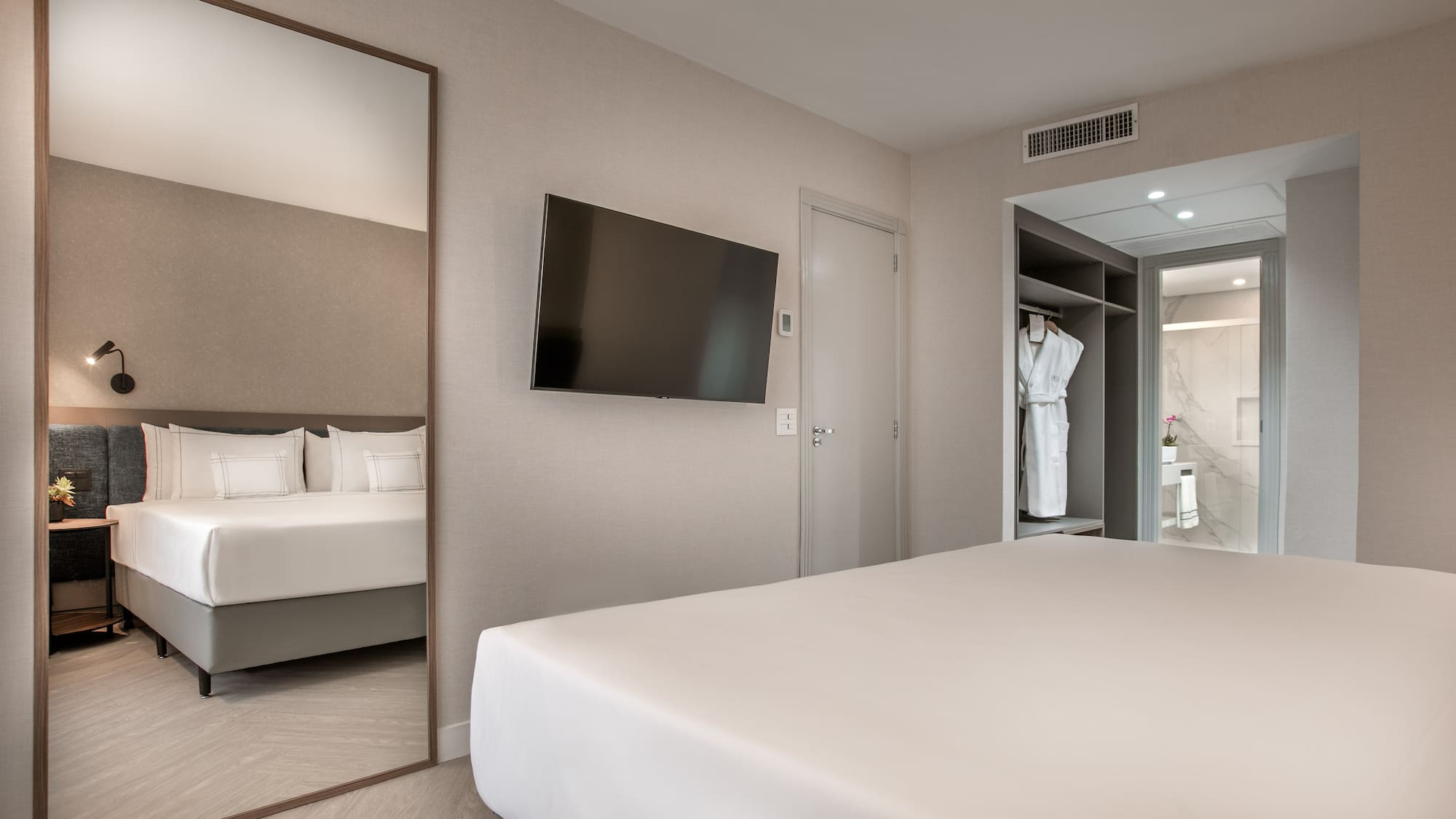 a room with a bed and a mirror