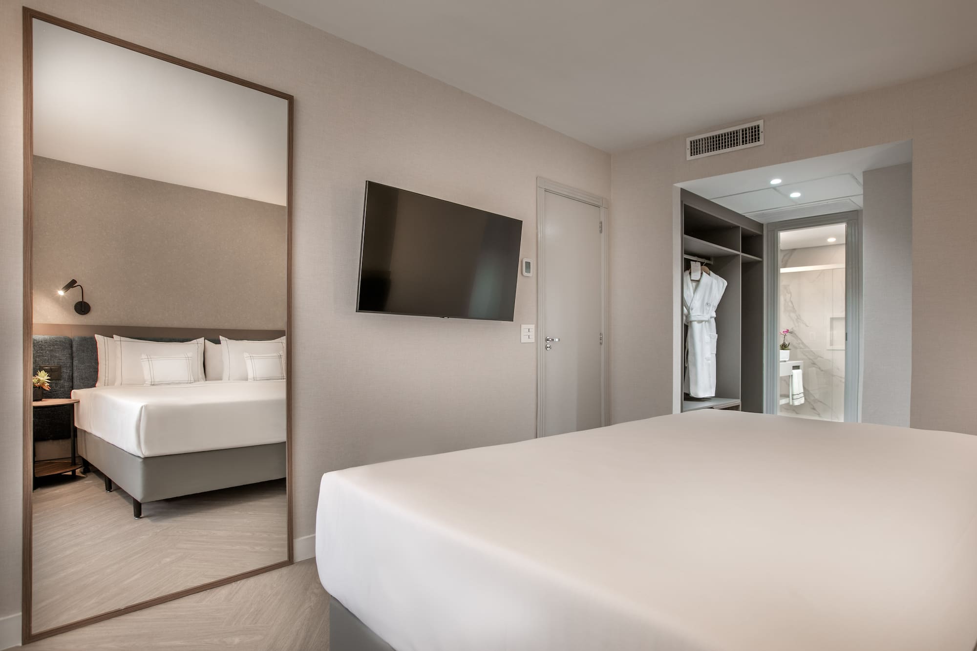 a room with a bed and a mirror