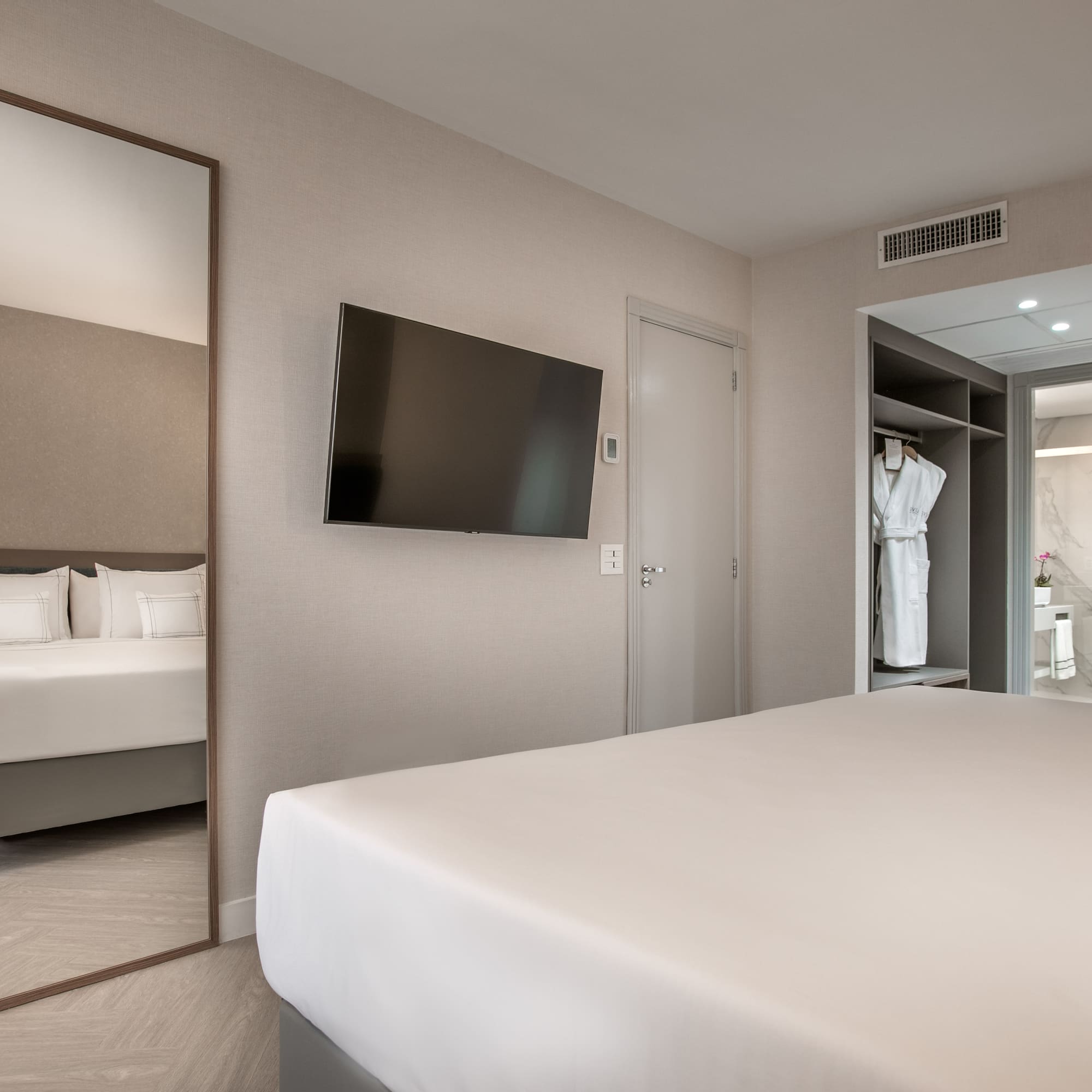 a room with a bed and a mirror