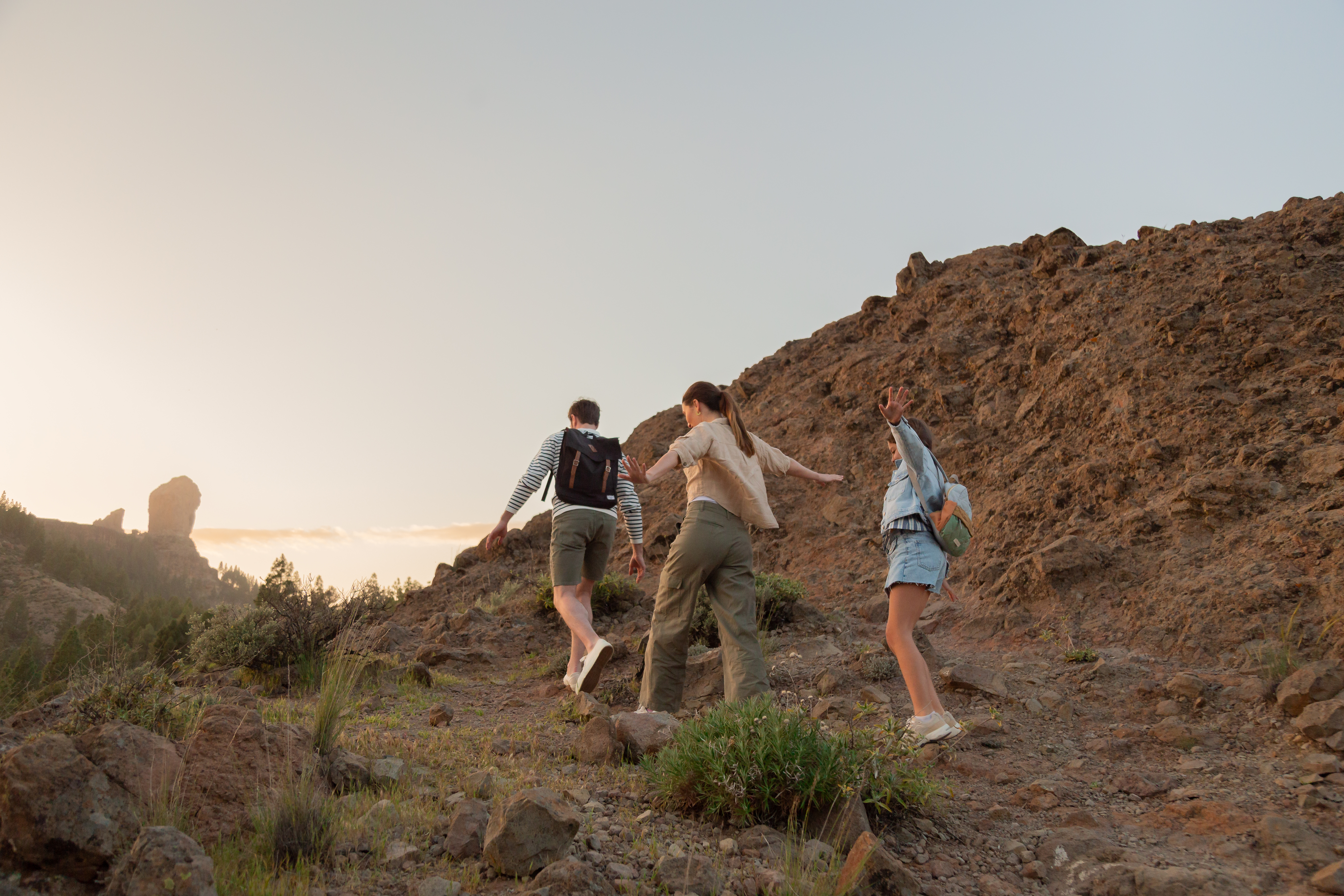 a group of people walking up a hill