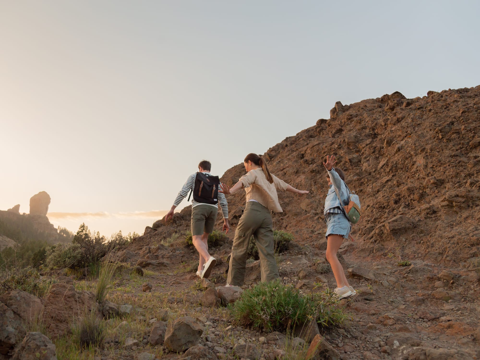 a group of people walking up a hill