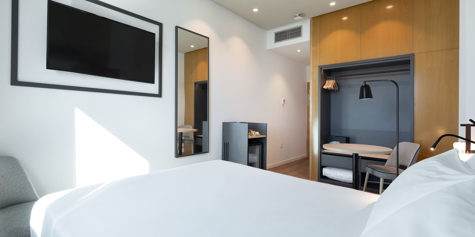 a room with a bed and a tv