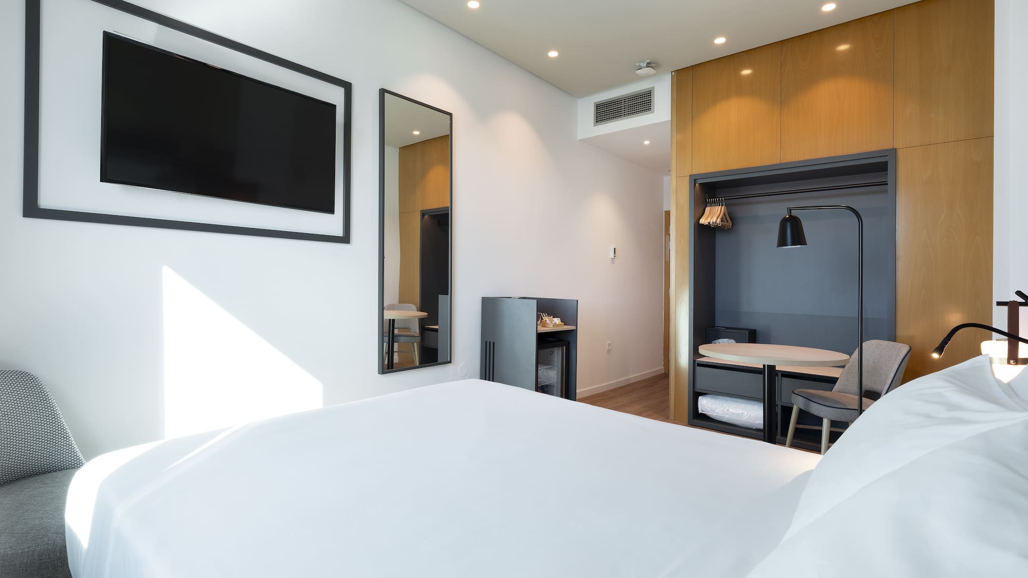 a room with a bed and a tv