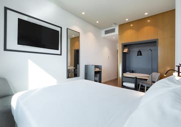 a room with a bed and a tv