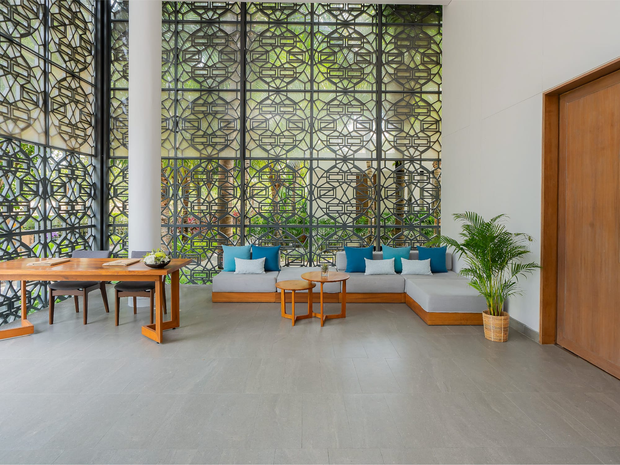 a room with a large screen with a couch and table