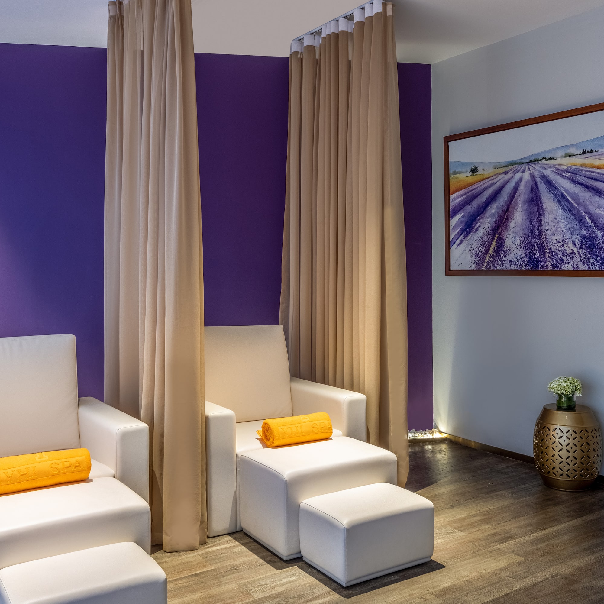a room with white chairs and purple walls
