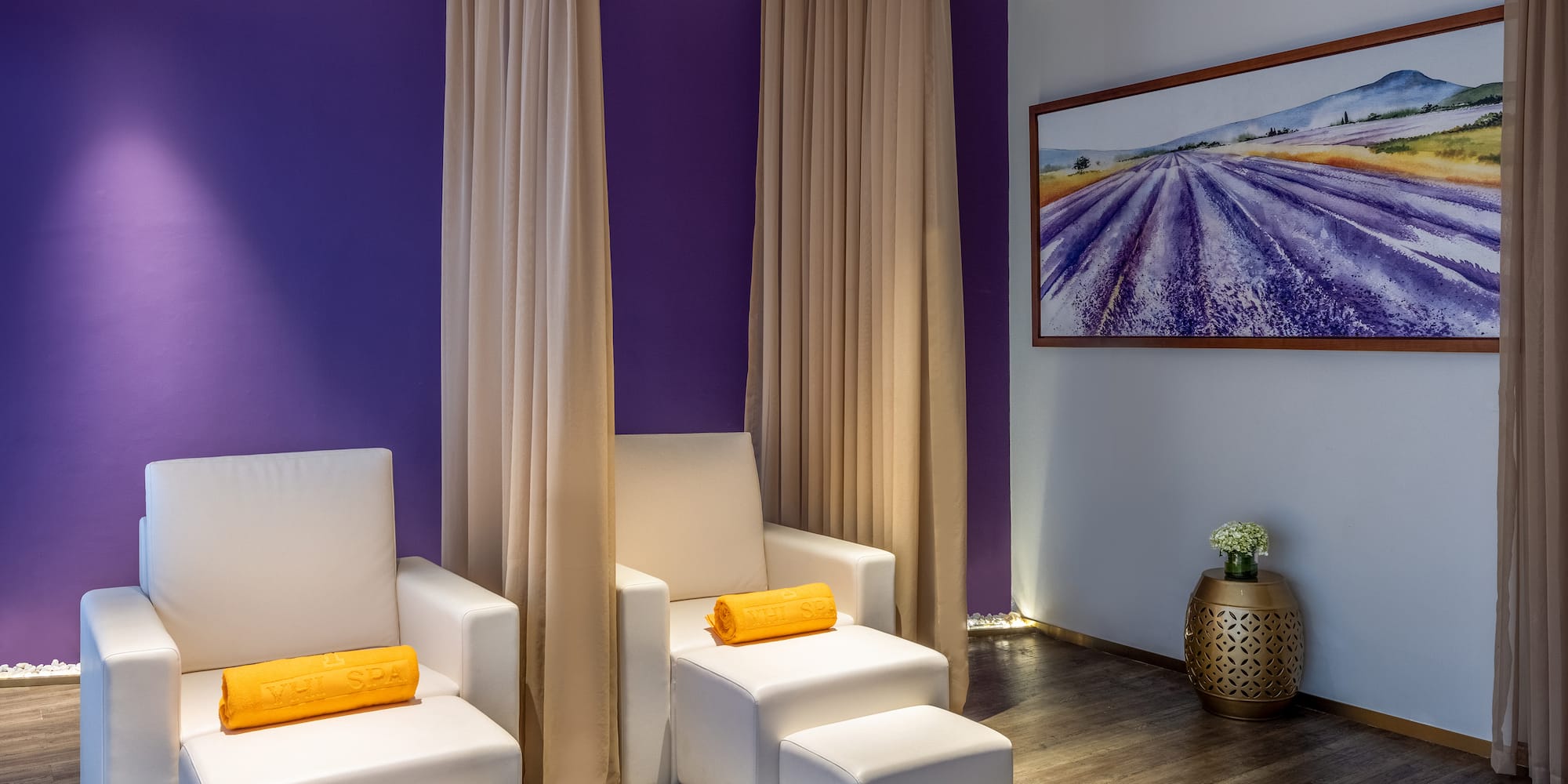 a room with white chairs and purple walls