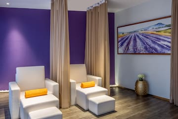 a room with white chairs and purple walls