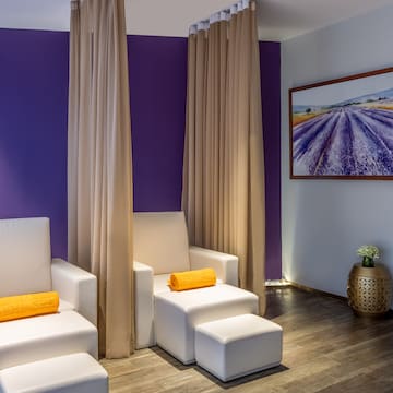 a room with white chairs and purple walls