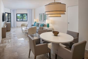 a living room with a table and chairs