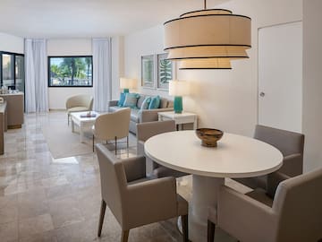 a living room with a table and chairs