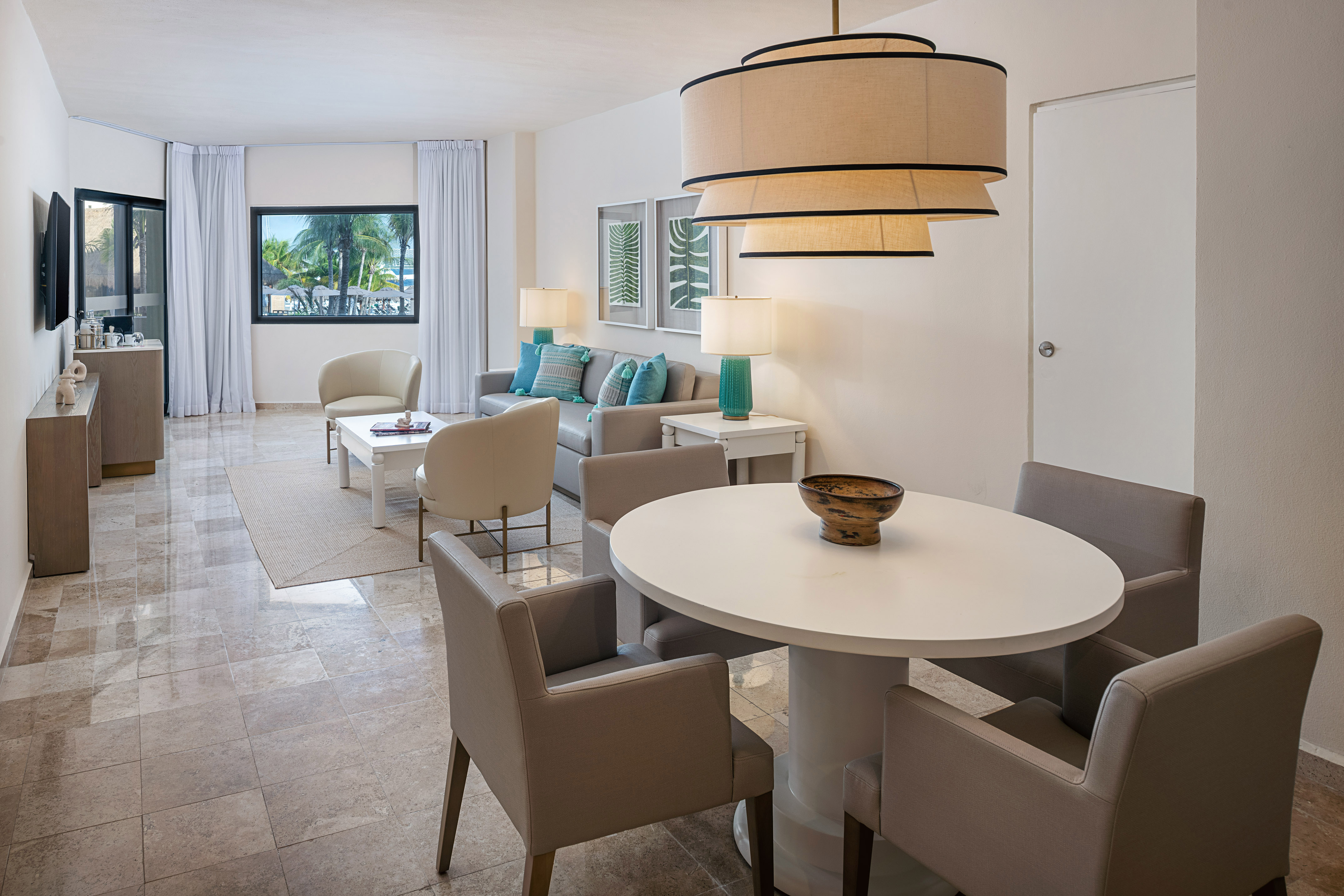 a living room with a table and chairs