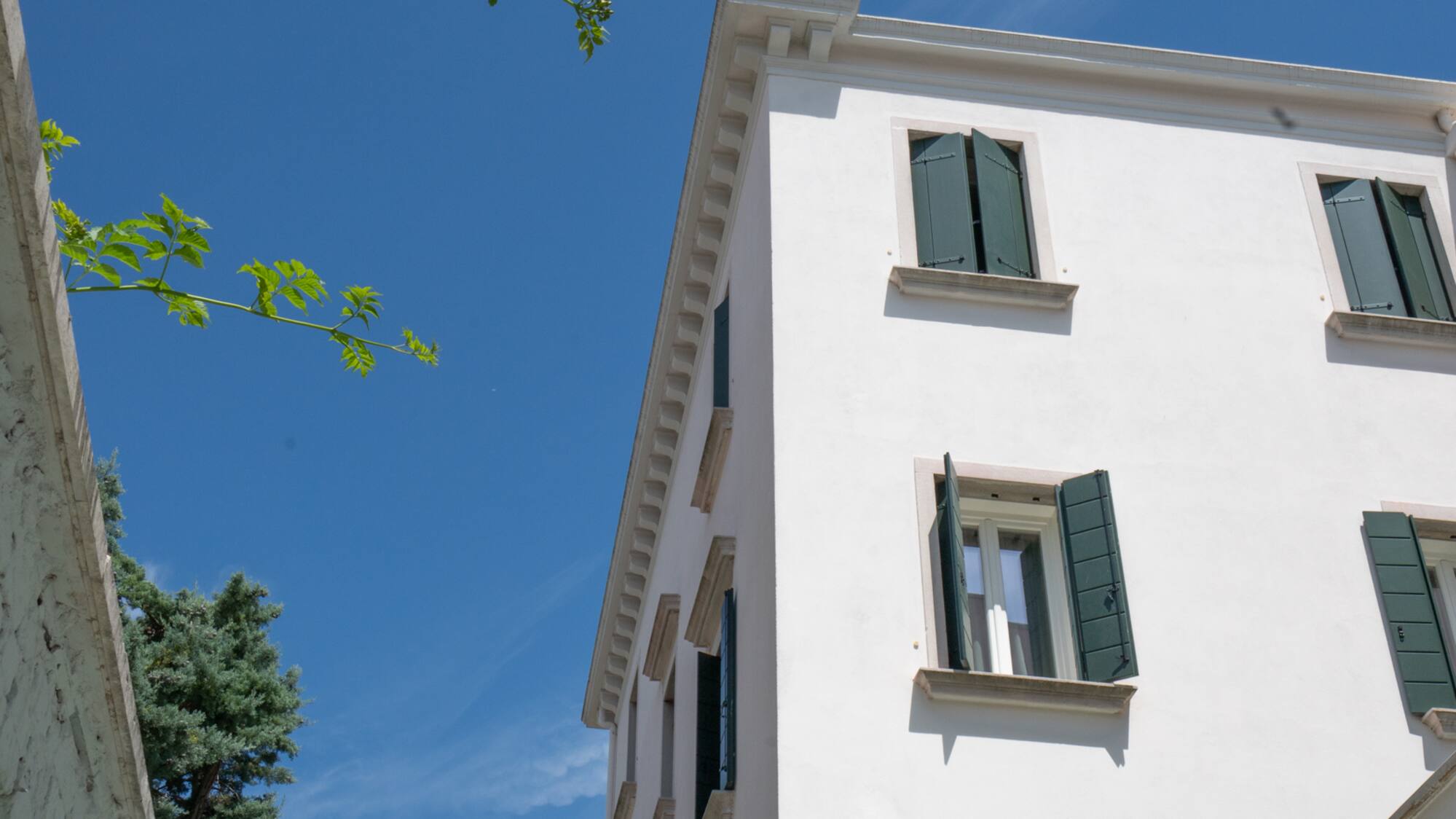 a white building with green shutters
