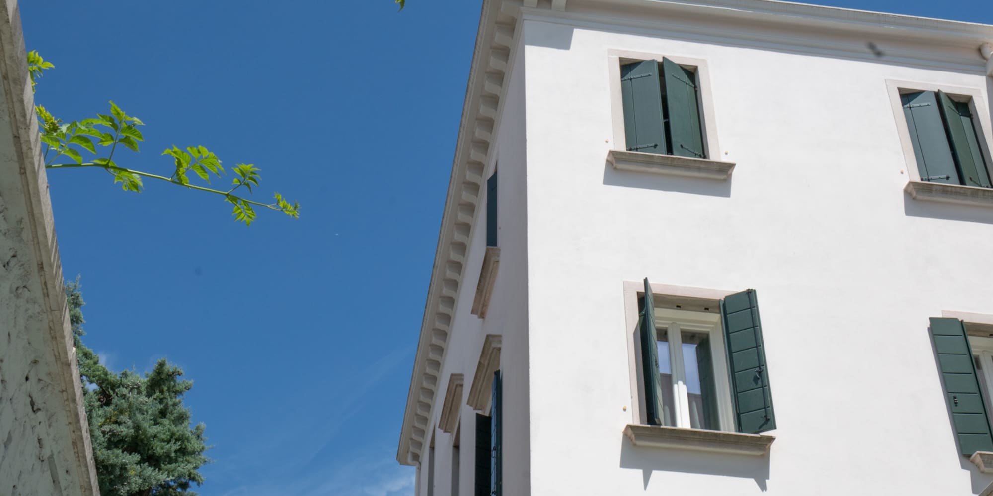 a white building with green shutters